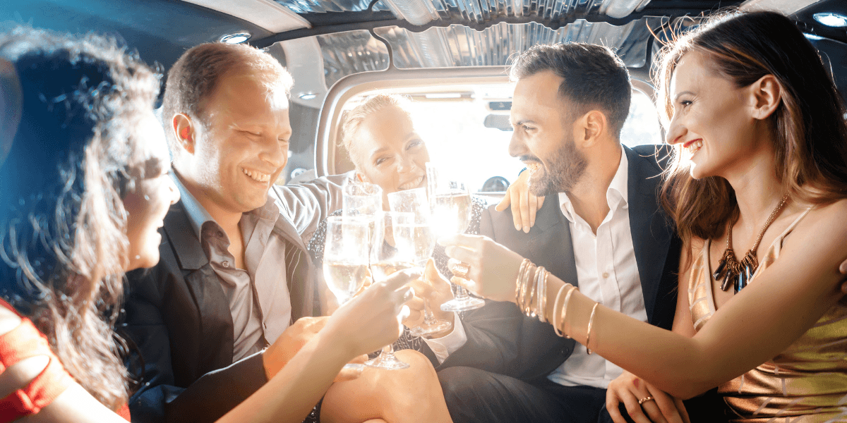 Friends toasting champagne in a luxury party shuttle on the way to Miami nightlife